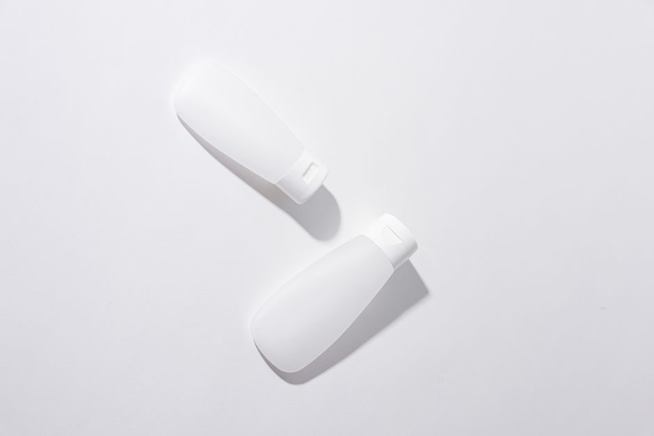 A skincare cleanser bottle running low on a bathroom surface